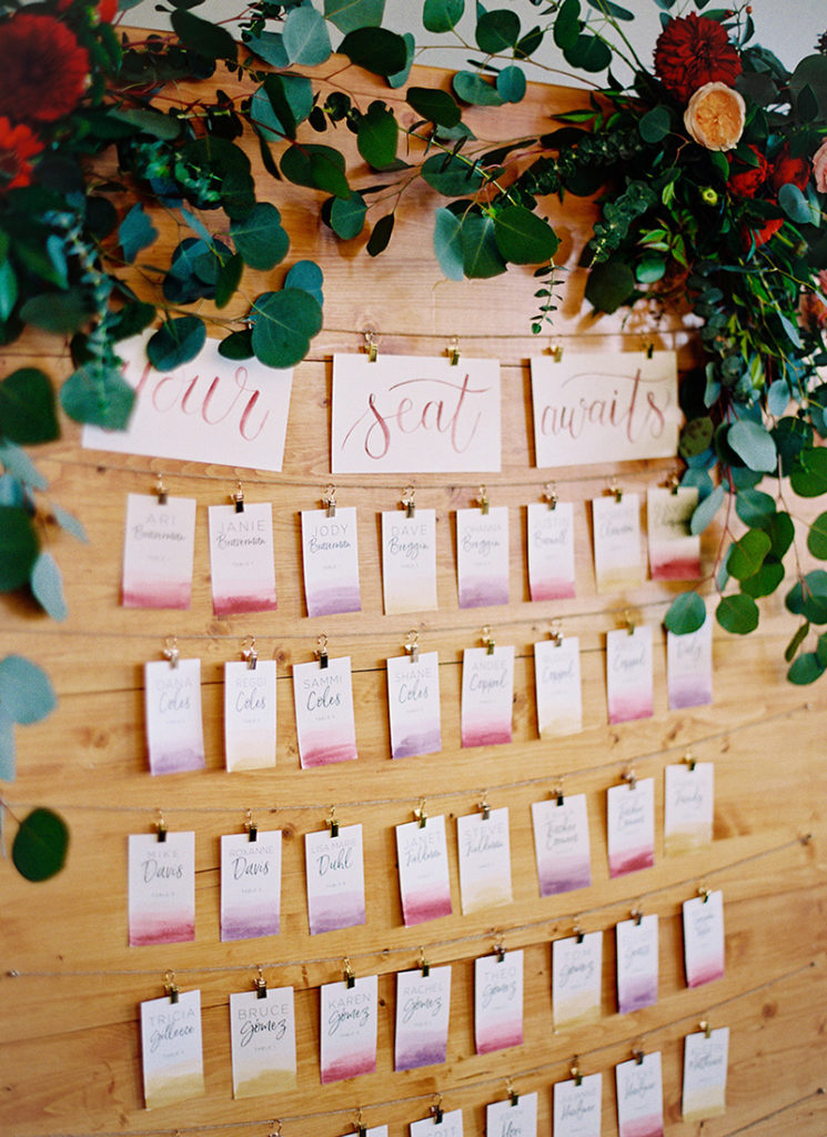 Escort Card Display - Watercolor Wash Cards on wooden display wall - Urban Fall Wedding