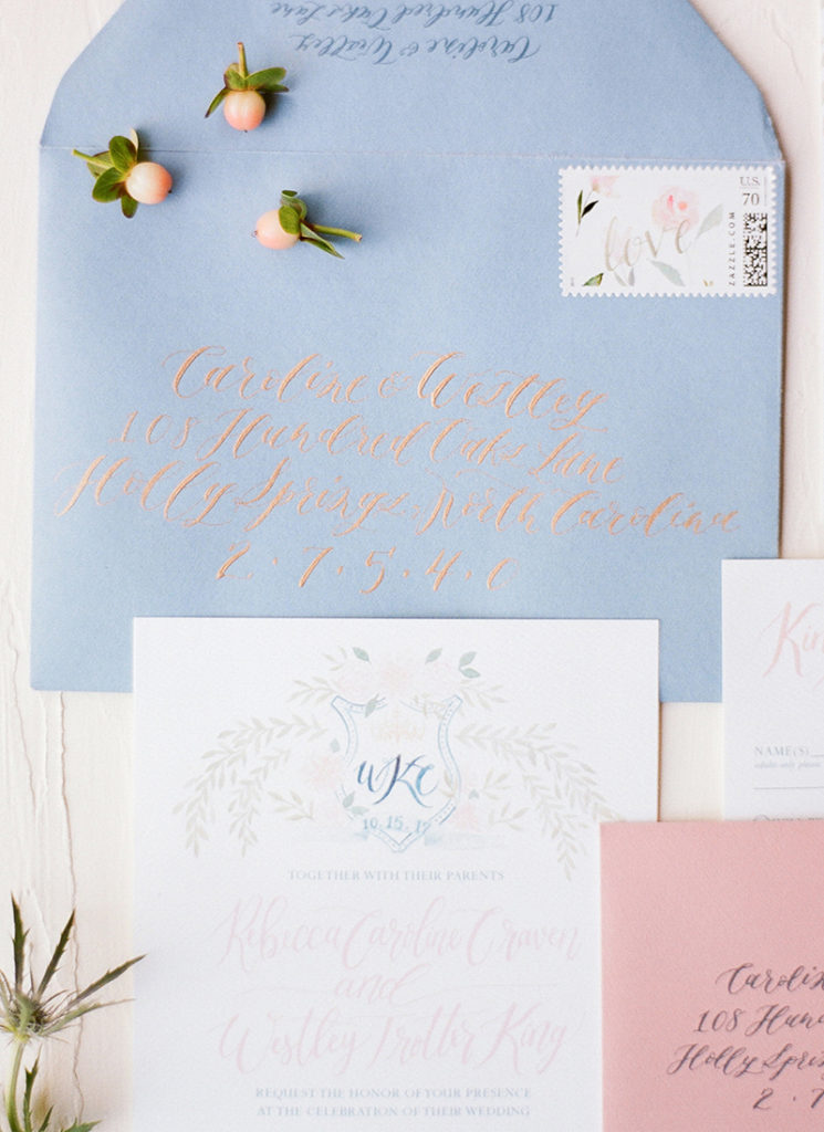 soft romantic custom wedding invitations with monogram crest and laurels, calligraphy